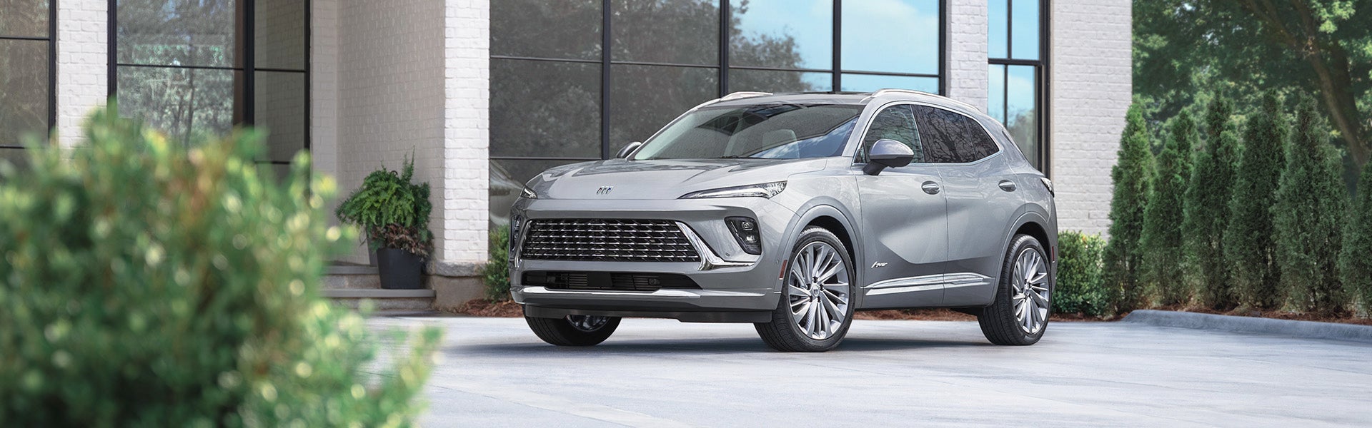 Silver Buick Envision parked under a building
