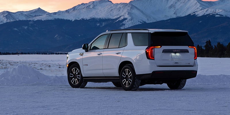 White 2024 GMC Yukon parked on icy mountains