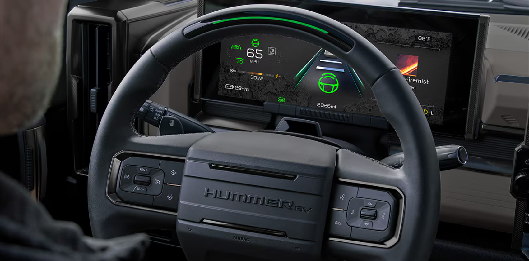 Hummer EV digital display with speed, range, and steering info on screen, plus a multifunction steering wheel.
