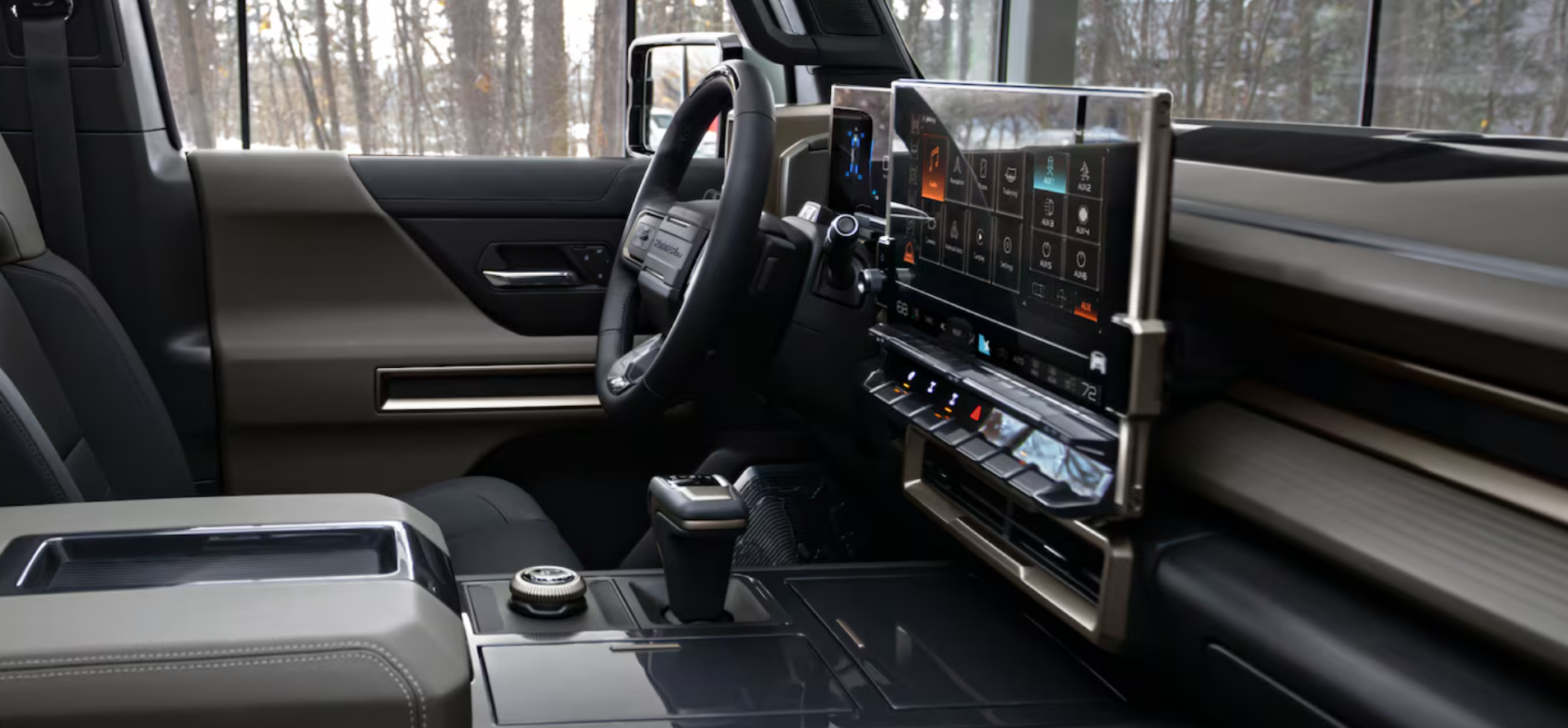 nterior of the GMC Hummer EV SUV featuring a high-tech dashboard with a large touchscreen, digital controls, and rugged design elements.