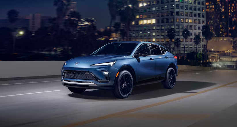 2026 Buick Envista SUV driving at night in city lights at Anderson Buick GMC of Abingdon