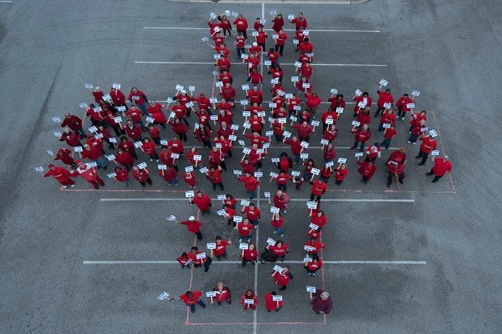 People forming a red cross